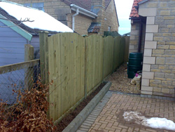 A photo after new installation of Jackson's convex feather board fence system with 25 year guarantee